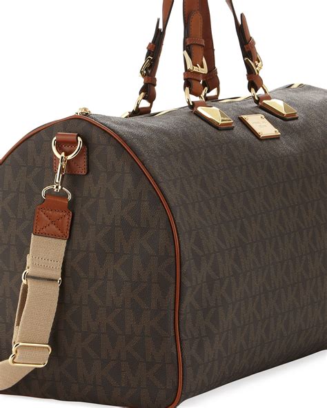 michael kors duffle bag with webbing|Michael Kors large suitcase.